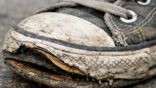 Peeling shoe sole showing wear damage and adhesive failure